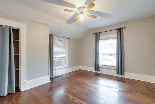 interior space with lofted ceiling, dark hardwood / wood-style floors, cooling unit, and ceiling fan