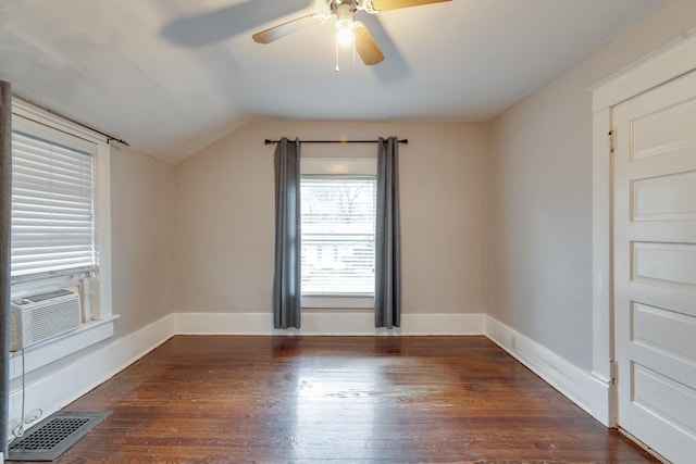 unfurnished room with cooling unit, vaulted ceiling, dark hardwood / wood-style floors, and ceiling fan