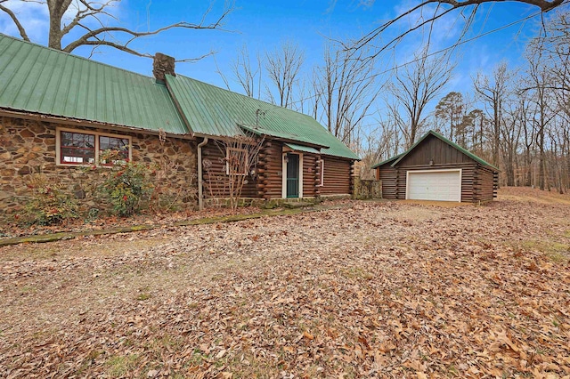 log cabin with a garage and an outdoor structure