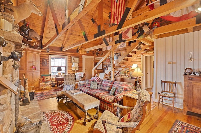 living room with wood ceiling, light hardwood / wood-style flooring, high vaulted ceiling, log walls, and beamed ceiling