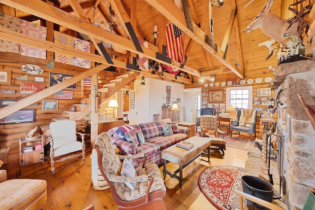 living room featuring vaulted ceiling with beams, hardwood / wood-style floors, and wooden ceiling