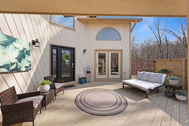 entrance to property with an outdoor hangout area and a deck