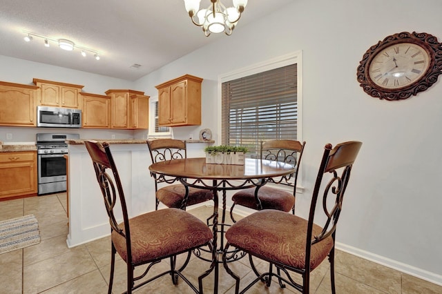 dining room featuring a chandelier and light tile patterned floors