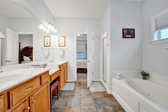 bathroom featuring vanity and independent shower and bath