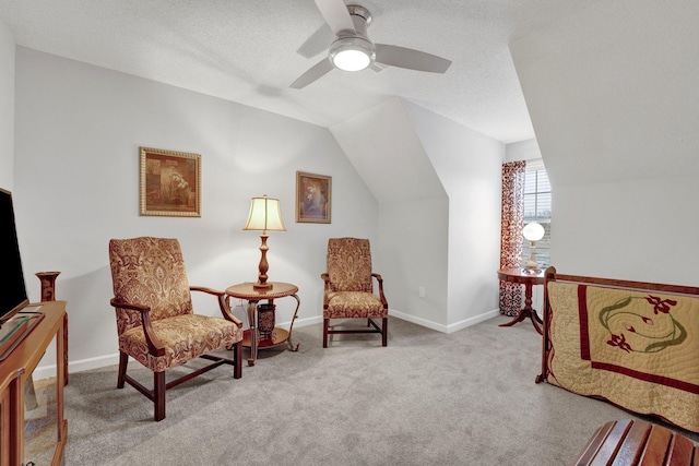 living area featuring vaulted ceiling, light carpet, and a textured ceiling