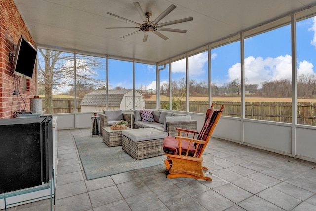 sunroom featuring ceiling fan and a wood stove