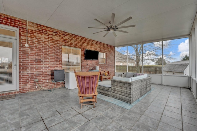 unfurnished sunroom featuring ceiling fan