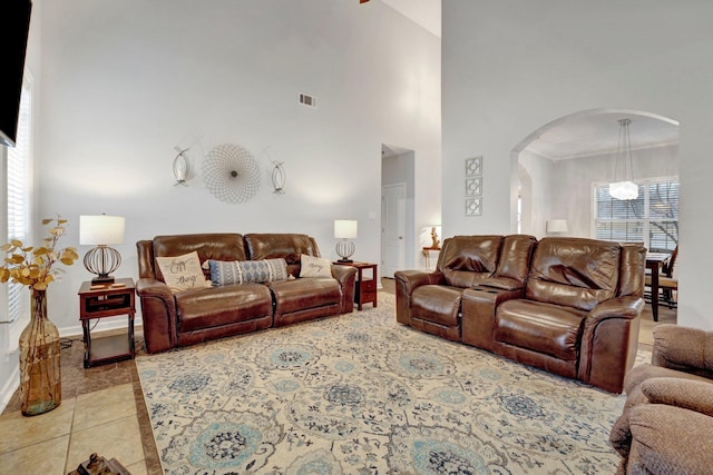 tiled living room with a high ceiling