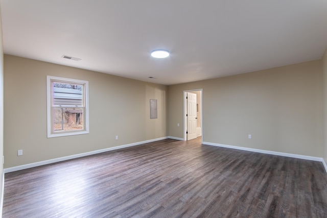 spare room featuring dark wood-type flooring