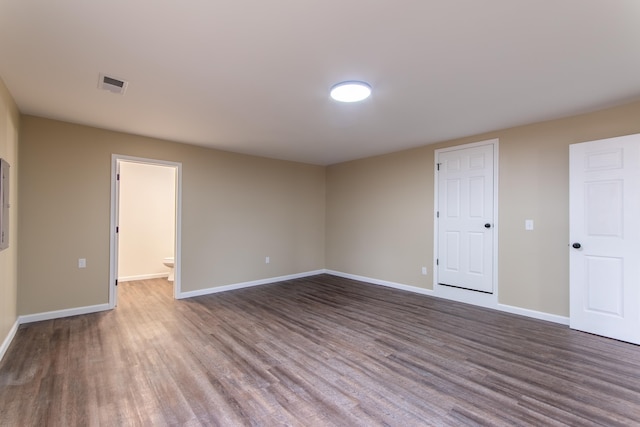 empty room with dark hardwood / wood-style flooring