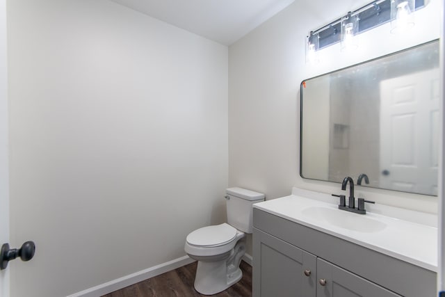 bathroom with vanity, wood-type flooring, and toilet