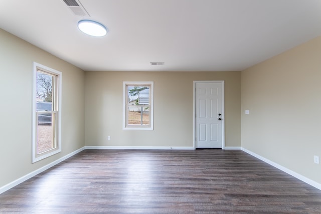 unfurnished room with dark wood-type flooring