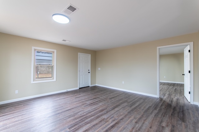 spare room featuring dark wood-type flooring