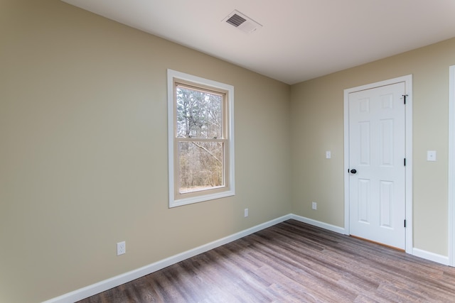 unfurnished room with wood-type flooring