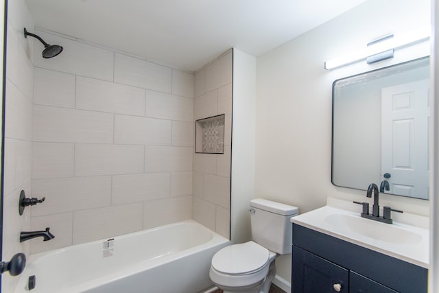 full bathroom featuring vanity, toilet, and tiled shower / bath