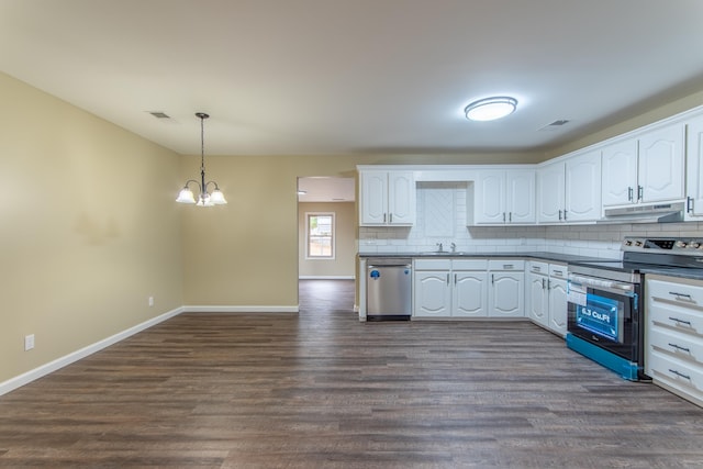 kitchen featuring appliances with stainless steel finishes, dark hardwood / wood-style flooring, hanging light fixtures, and white cabinets