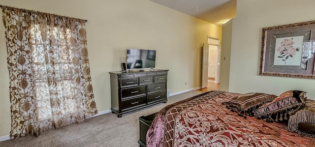 bedroom featuring light colored carpet and lofted ceiling