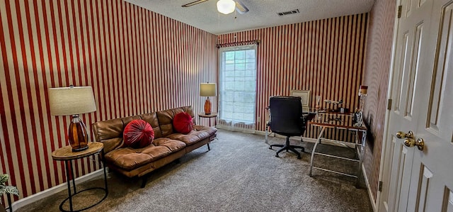 carpeted office space with ceiling fan and a textured ceiling