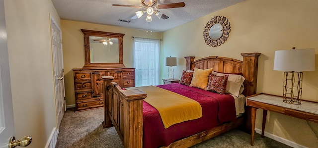 bedroom with dark colored carpet, ceiling fan, and a textured ceiling