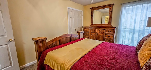 bedroom with multiple windows and carpet flooring