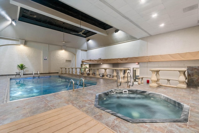 view of swimming pool featuring an indoor hot tub