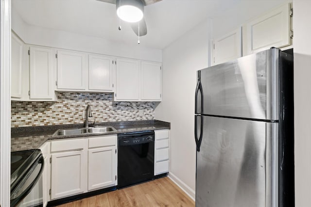 kitchen with sink, stainless steel fridge, white cabinetry, electric range oven, and black dishwasher