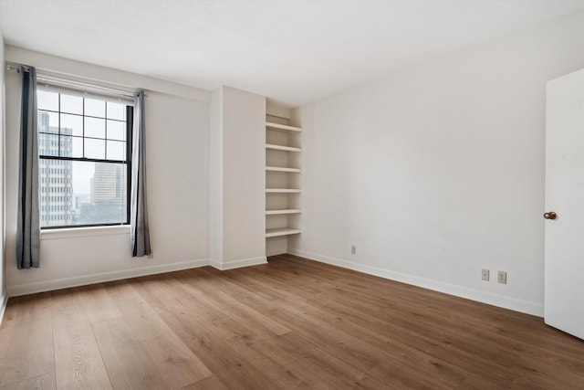 unfurnished bedroom with wood-type flooring