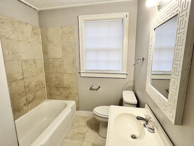 full bathroom with tiled shower / bath, sink, and toilet