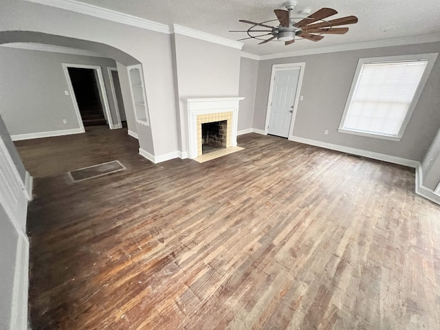 unfurnished living room with crown molding, a fireplace, and dark hardwood / wood-style flooring