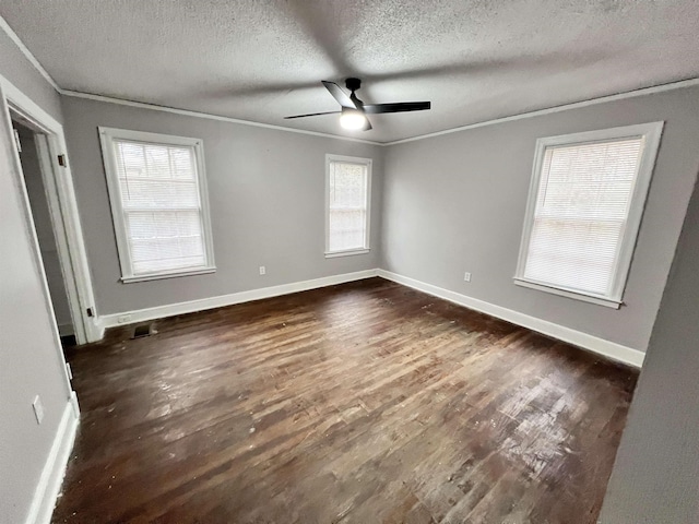 unfurnished room featuring crown molding, ceiling fan, dark hardwood / wood-style flooring, and a textured ceiling