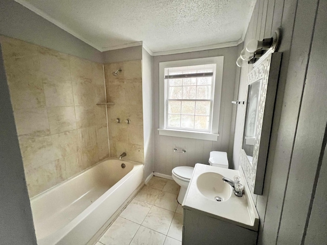 full bathroom featuring toilet, crown molding, a textured ceiling, vanity, and tiled shower / bath combo