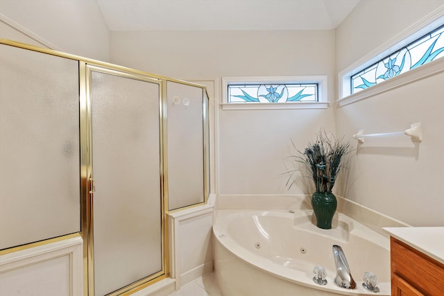 bathroom with vanity and shower with separate bathtub