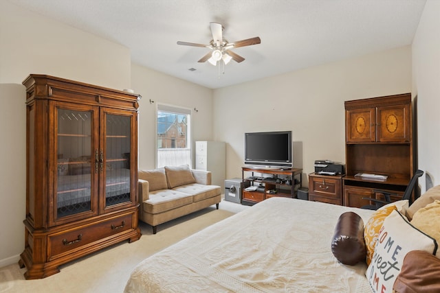 bedroom with ceiling fan and light colored carpet