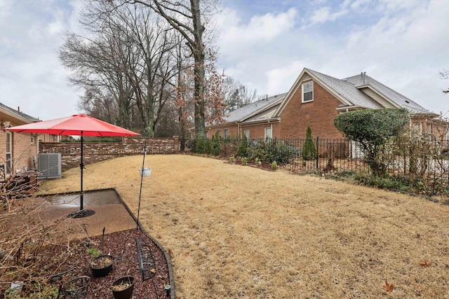 view of yard with cooling unit and a patio