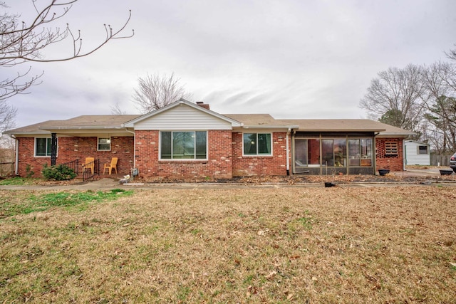 single story home with a front yard and a sunroom