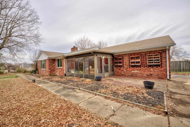 exterior space with a sunroom and a patio