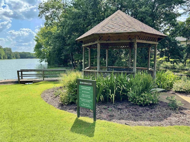 view of property's community featuring a water view, a yard, and a gazebo