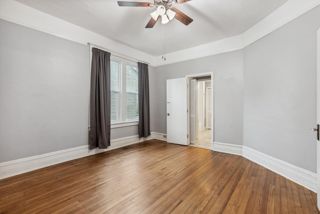 spare room featuring hardwood / wood-style flooring and ceiling fan