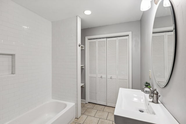 bathroom with vanity, tiled shower / bath combo, and tile patterned floors