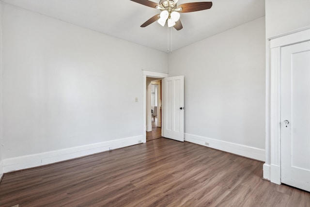 unfurnished bedroom with ceiling fan and dark hardwood / wood-style flooring