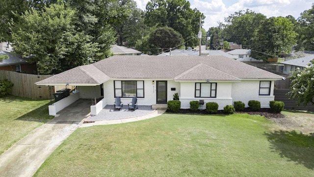 ranch-style house featuring a carport and a front yard