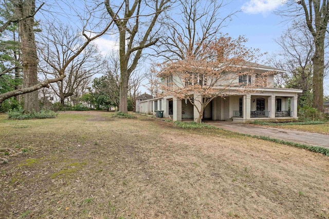 view of front of house featuring a front yard and covered porch