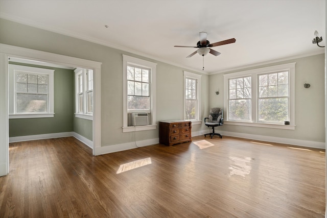 spare room with wood-type flooring, ornamental molding, cooling unit, and ceiling fan