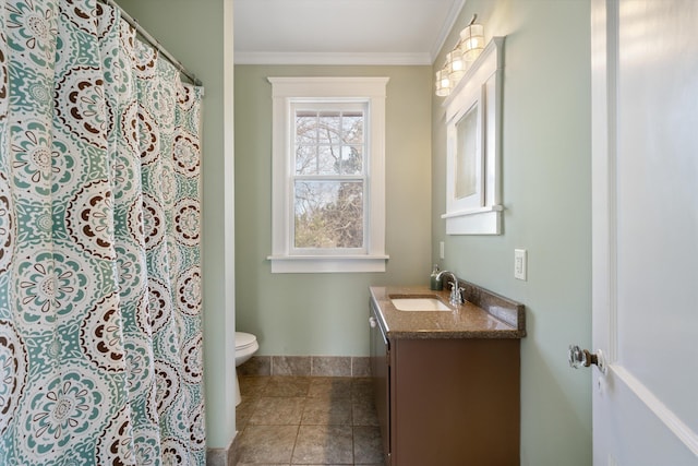 bathroom featuring crown molding, vanity, and toilet