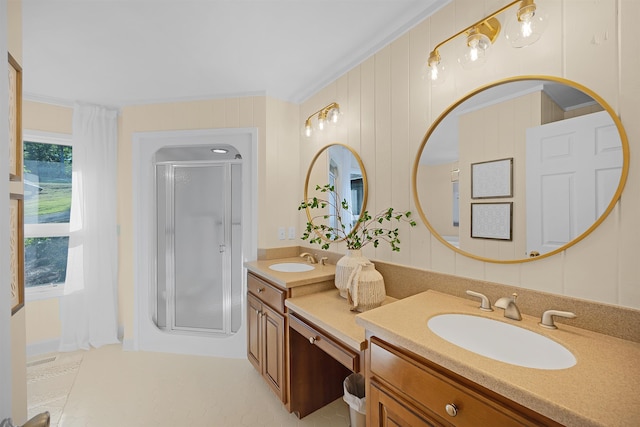 bathroom with crown molding, vanity, and a shower with shower door