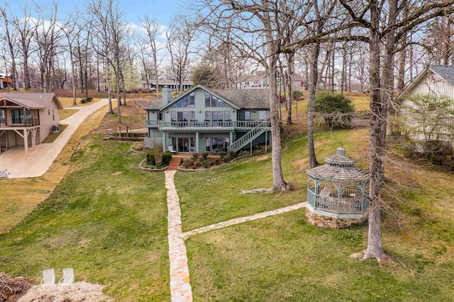 rear view of house featuring a yard and a deck