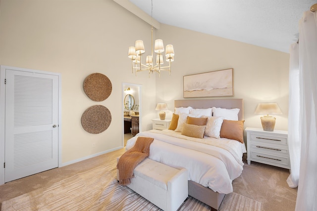 carpeted bedroom with an inviting chandelier, ensuite bath, and high vaulted ceiling