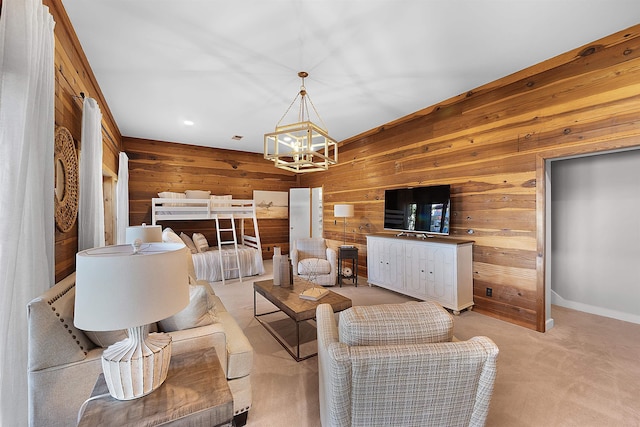 living room with light colored carpet, a notable chandelier, and wooden walls