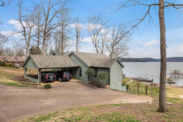 view of side of property with a water view and a carport