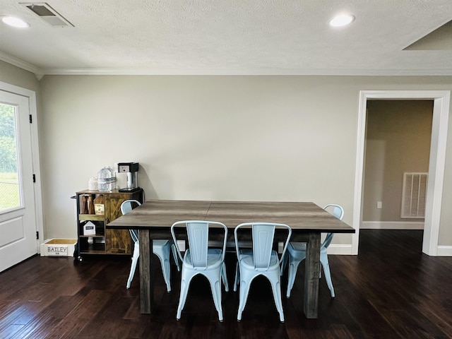 dining area featuring ornamental molding, dark hardwood / wood-style flooring, and a textured ceiling